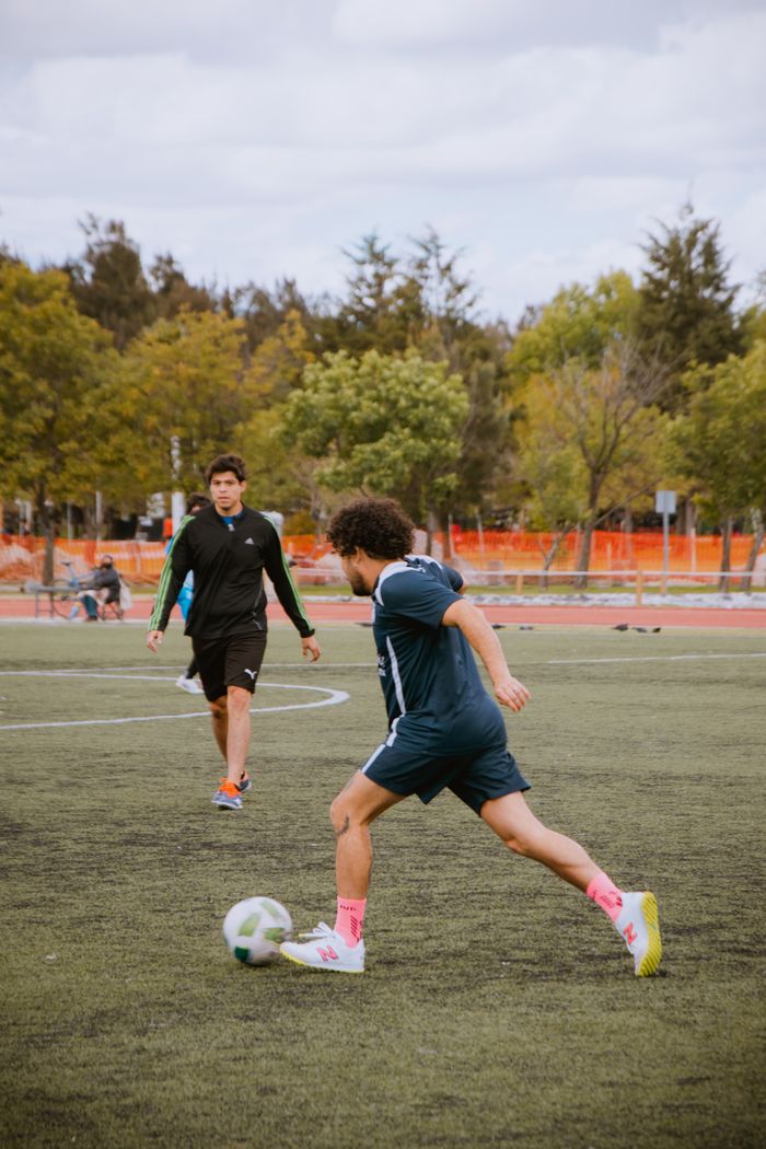 Young athletes practicing soccer at a park in Puebla, Mexico, showcasing skill and teamwork.